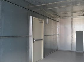 Stainless steel lines the interior of modular shelter for water treatment