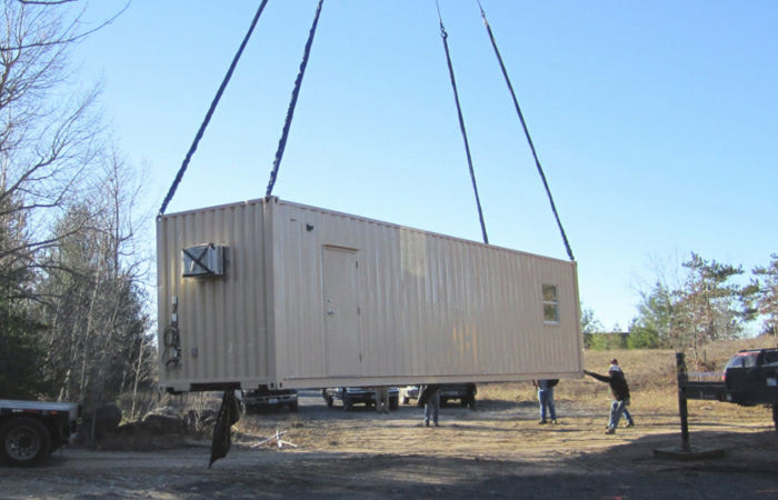 Portable conex container cabin being placed at a remote location without a foundation. Portable conex container cabin being placed at a remote location without a foundation.