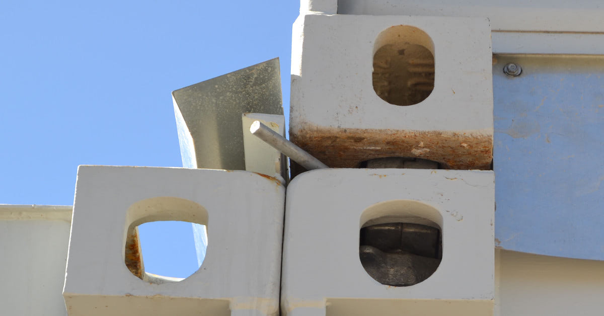 Twist lock that secures a two story shipping container building