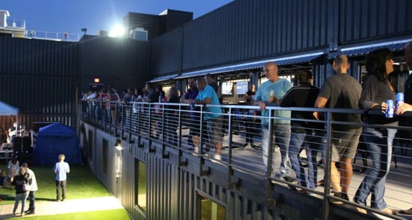 People enjoy a beer inside Fortress Obetz, a shipping container-based stadium