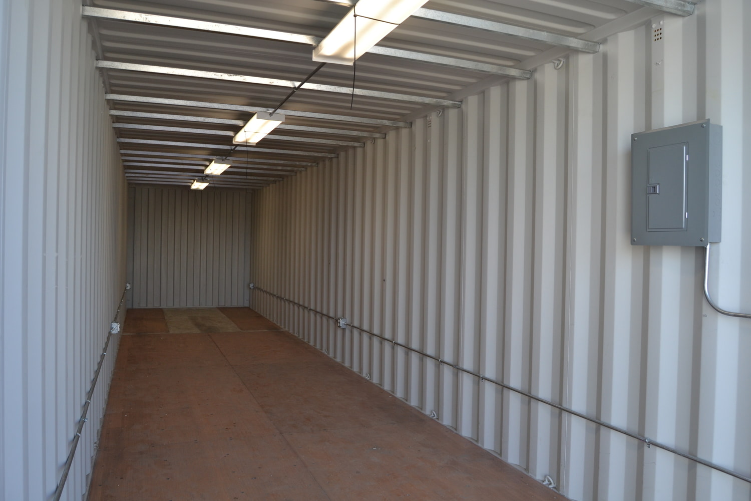 Interior of shipping container modified into portable storage shed.