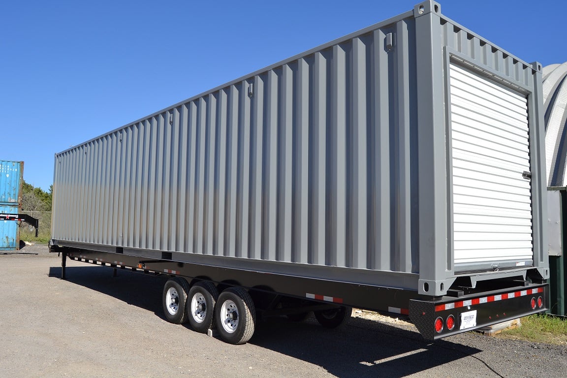 Storage container on a chassis with an overhead door