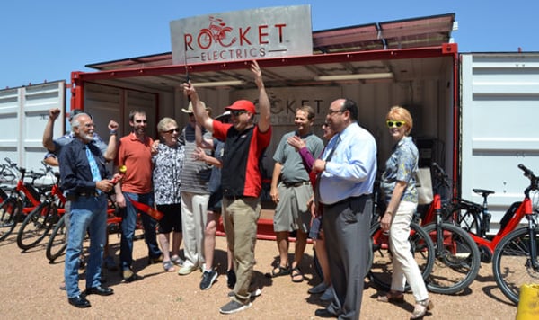 Rocket Electrics and its supporters cheer after cutting the ribbon to their store front location.