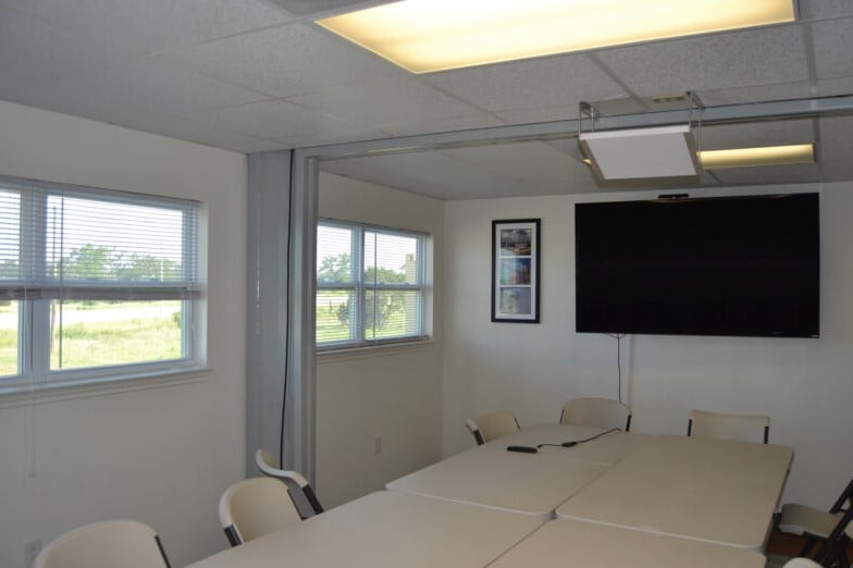 A container-based conference room finished out with drywall.