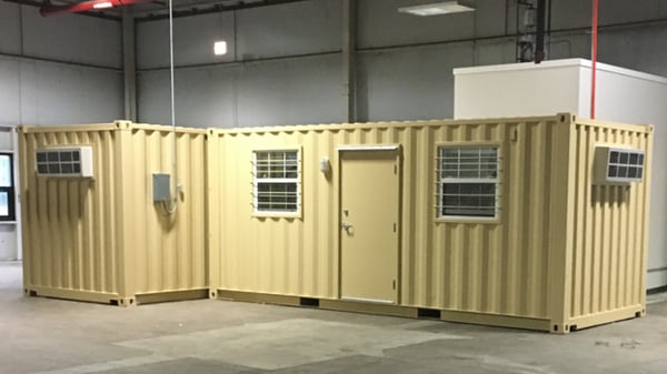 These mobile container offices reside inside a warehouse.