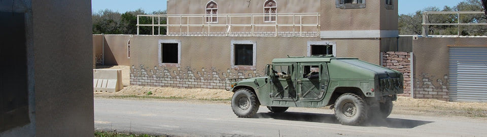 Military vehicle driving through shipping container based MOUT training facility. Military vehicle driving through shipping container based MOUT training facility.