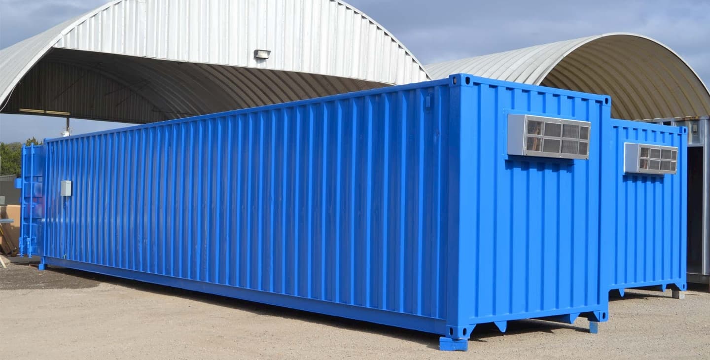 blue-shipping-containers-in-front-of-hangers