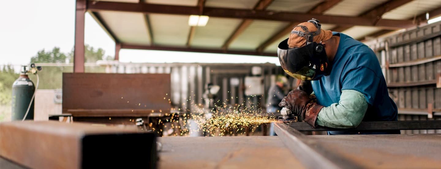 worker-with-grinder-working-on-a-frame-with-sparks (1)