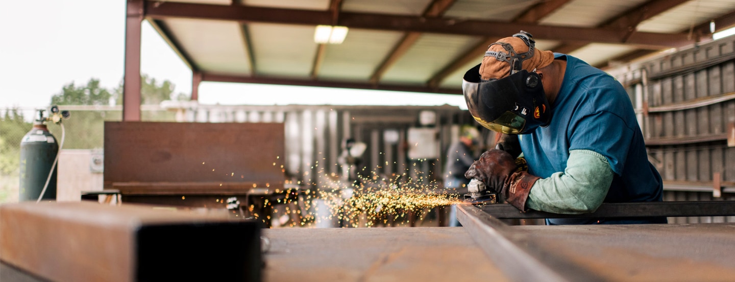 worker-with-grinder-working-on-a-frame-with-sparks
