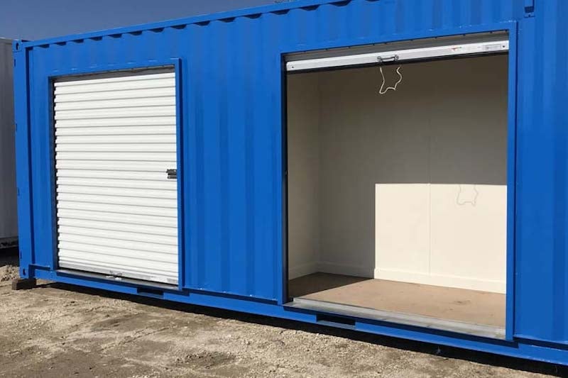 Dual overhead doors in a blue shipping container