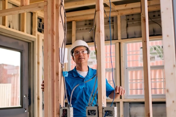 Construction professional looking at wood interior framing