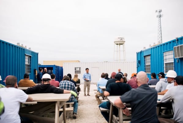 Modified Shipping Container CEO presenting to his team