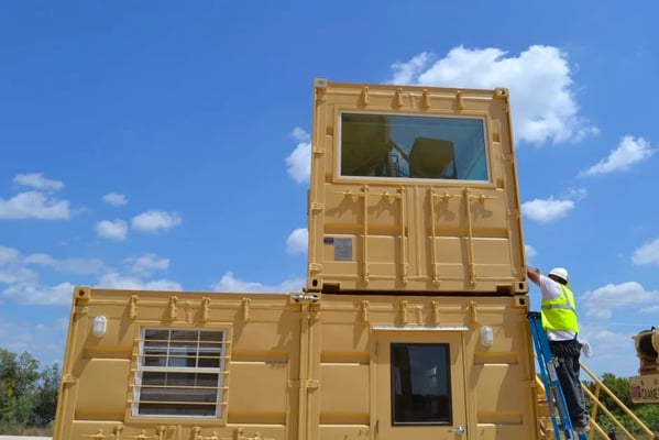 Multi-unit shipping container building designed for future expansion