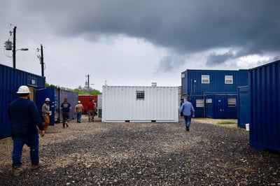 stormy sky with modified containers and workers