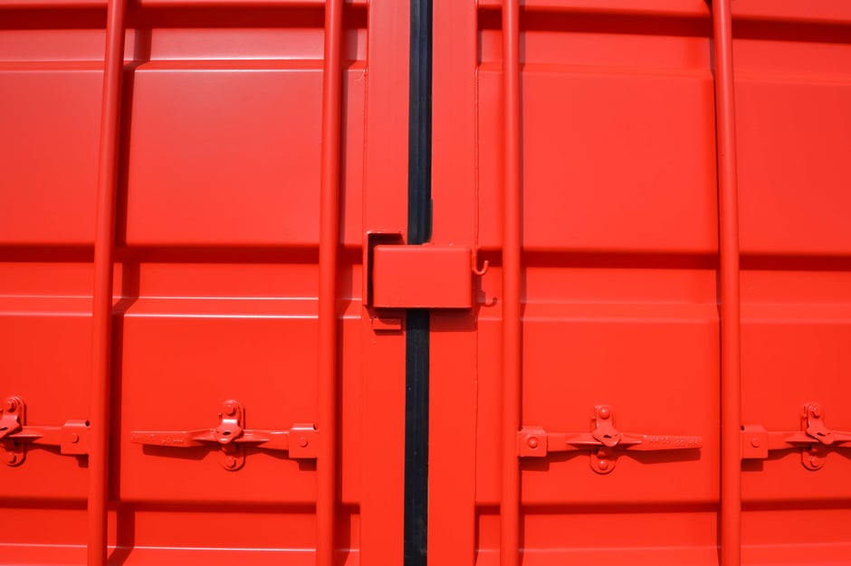 Red shipping container cargo doors with lock box