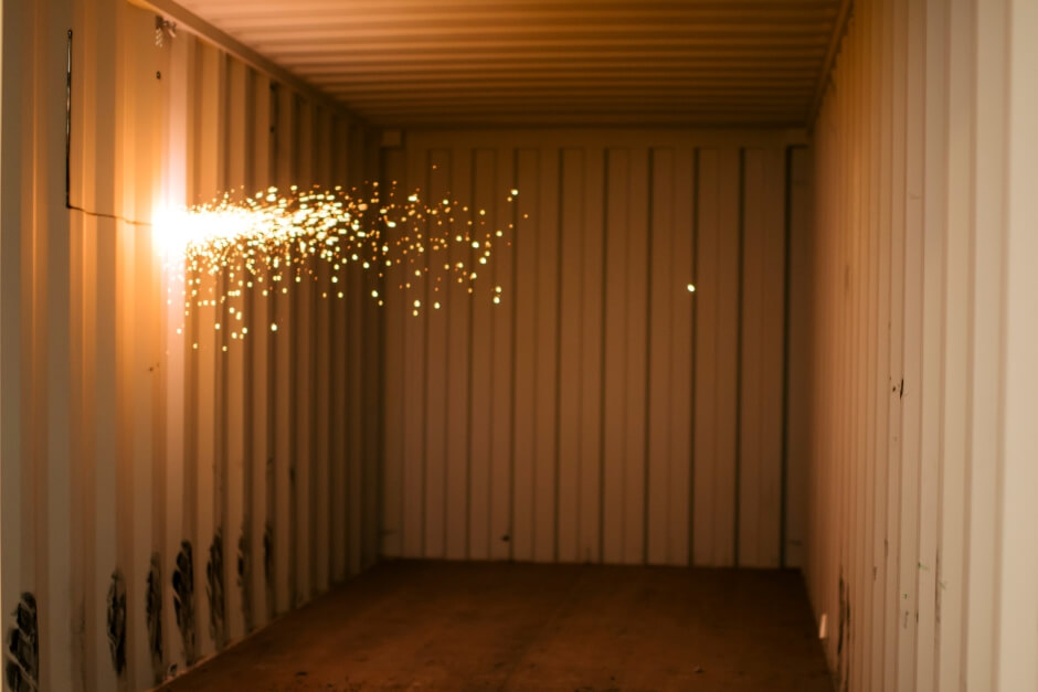 sparks from welding a shipping container