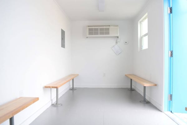 inside of shipping container breakroom with benches