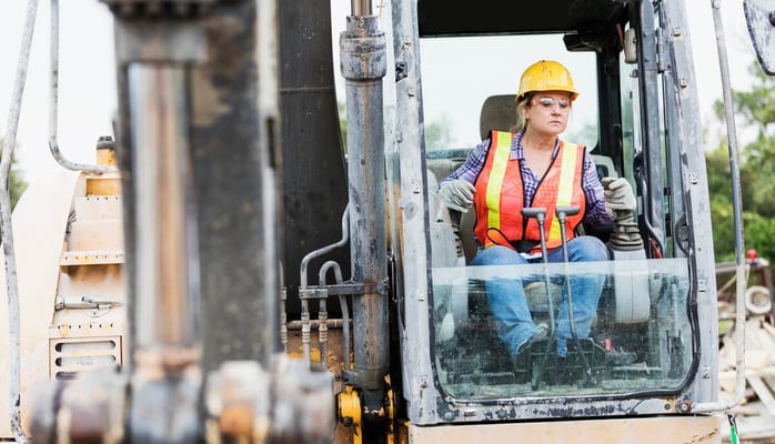 woman operating an earth mover on a construction site