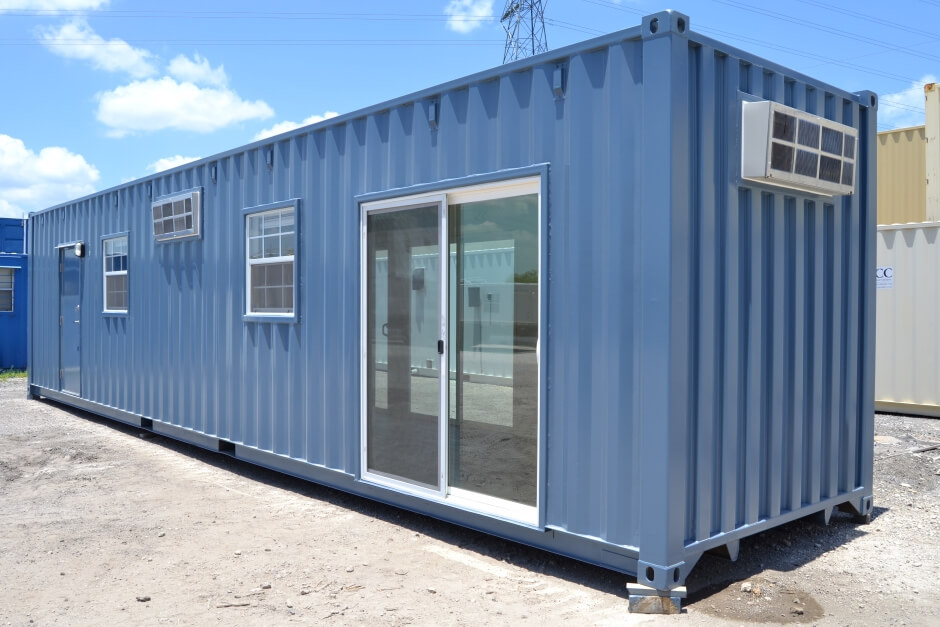 Exterior blue shipping container office with sliding glass doors