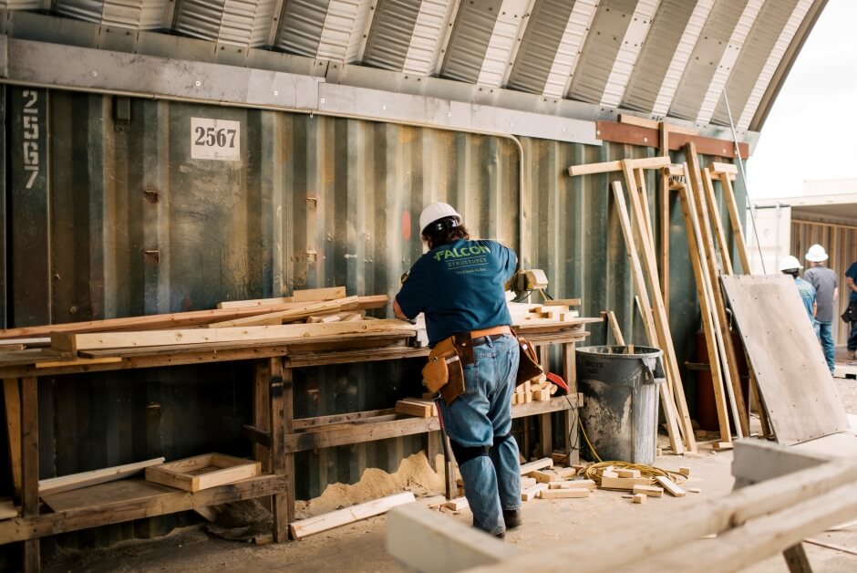 worker cutting plywood at manufacturing facility