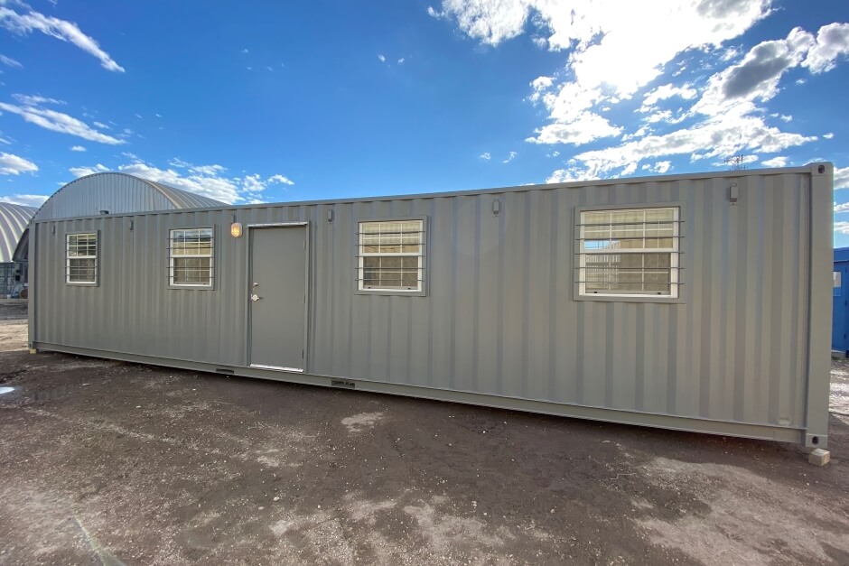 40-foot gray steel shipping container office with four windows and a door 