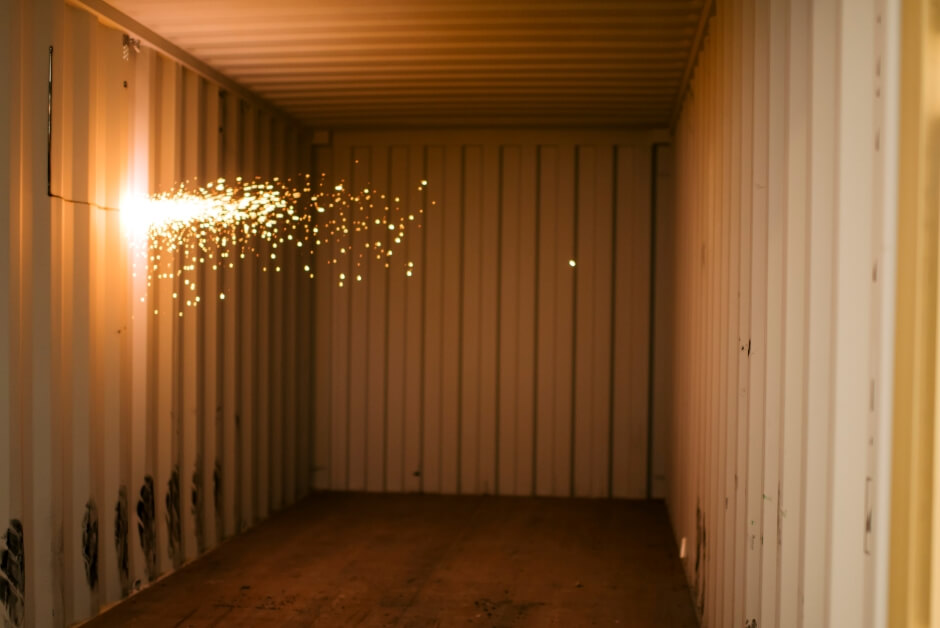 cutting into side of shipping container