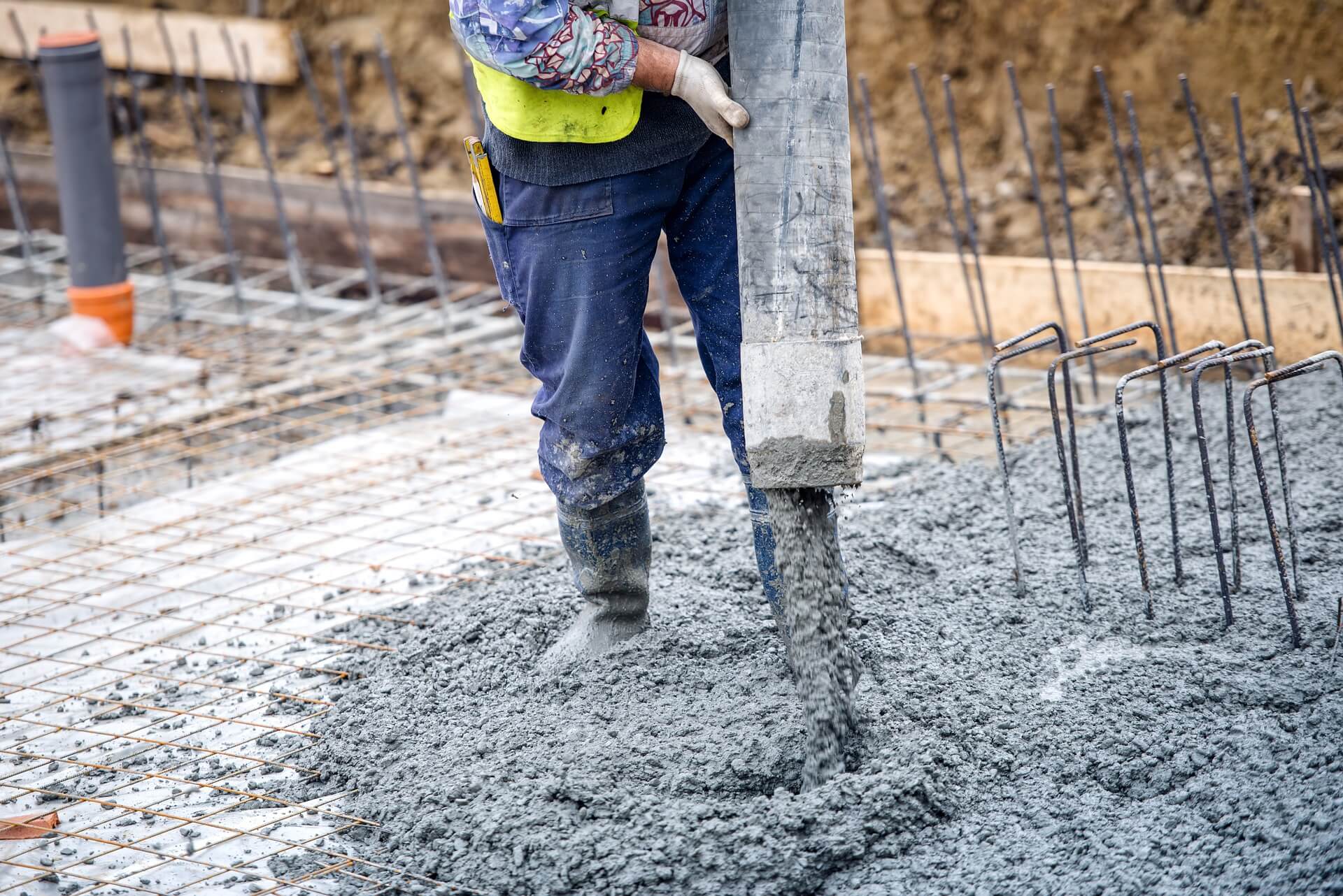 man pouring concrete foundation