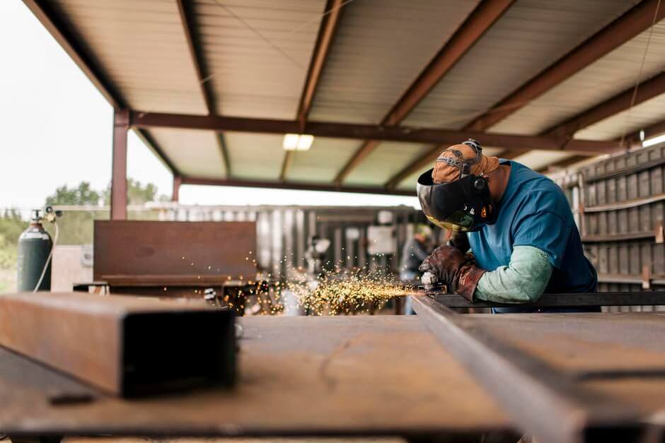 man welding steel
