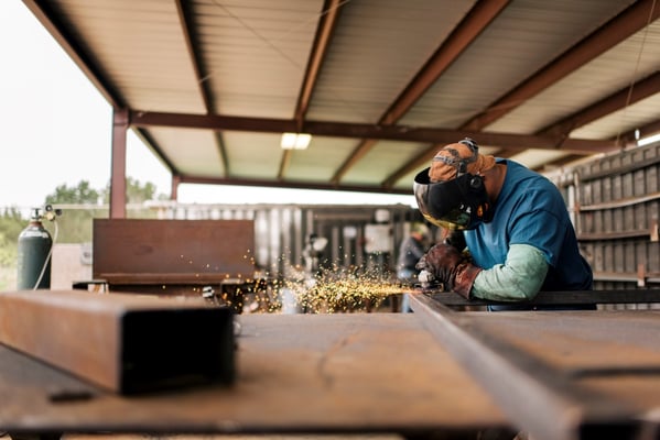 worker grinding in a manufacturing facility