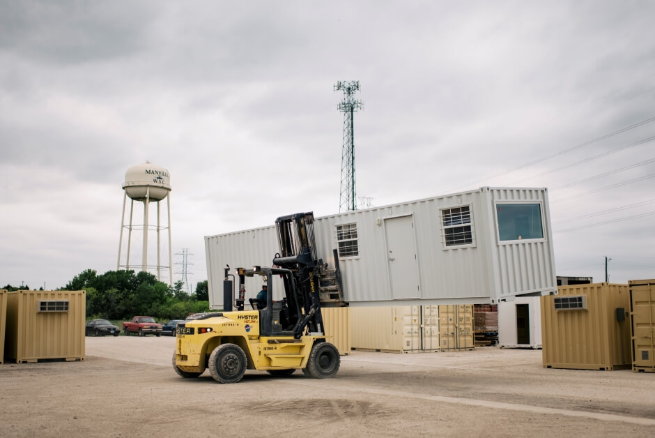 forklift transporting a shipping  container office