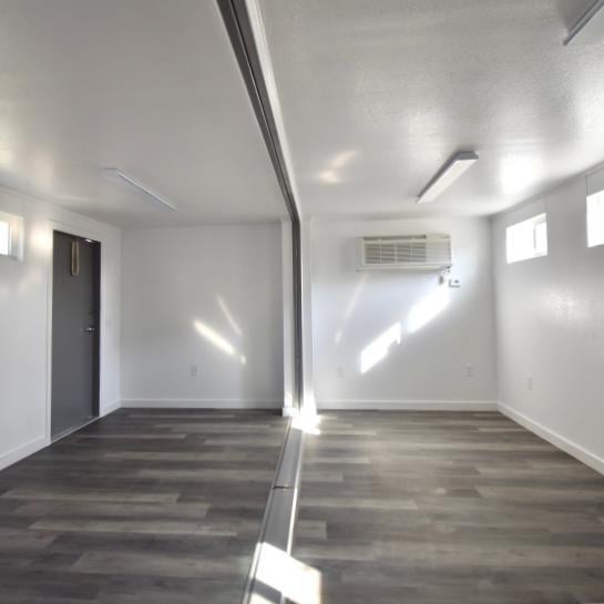 interior of double-wide container structure with wood floors