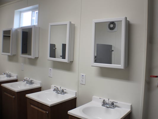 four sinks and mirrors in a shipping container bathroom
