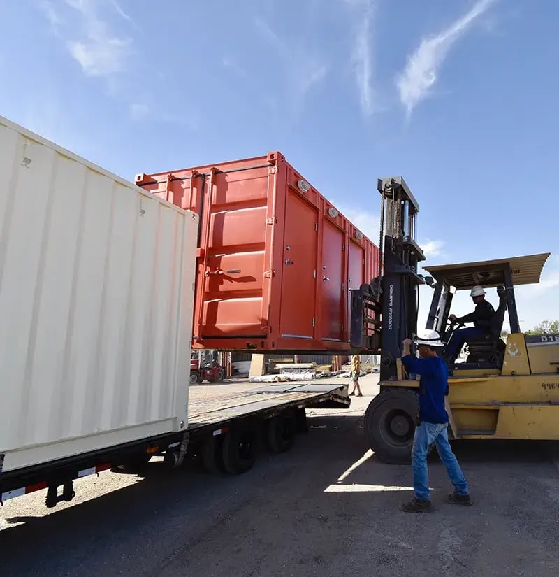 tangerine-shipping-container-lifted-by-forklift