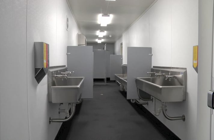 custom modification shipping container bathroom design with metal sinks and stalls