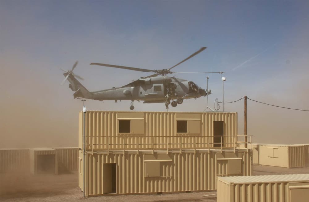 military-helicopter-flying-over-multi-container