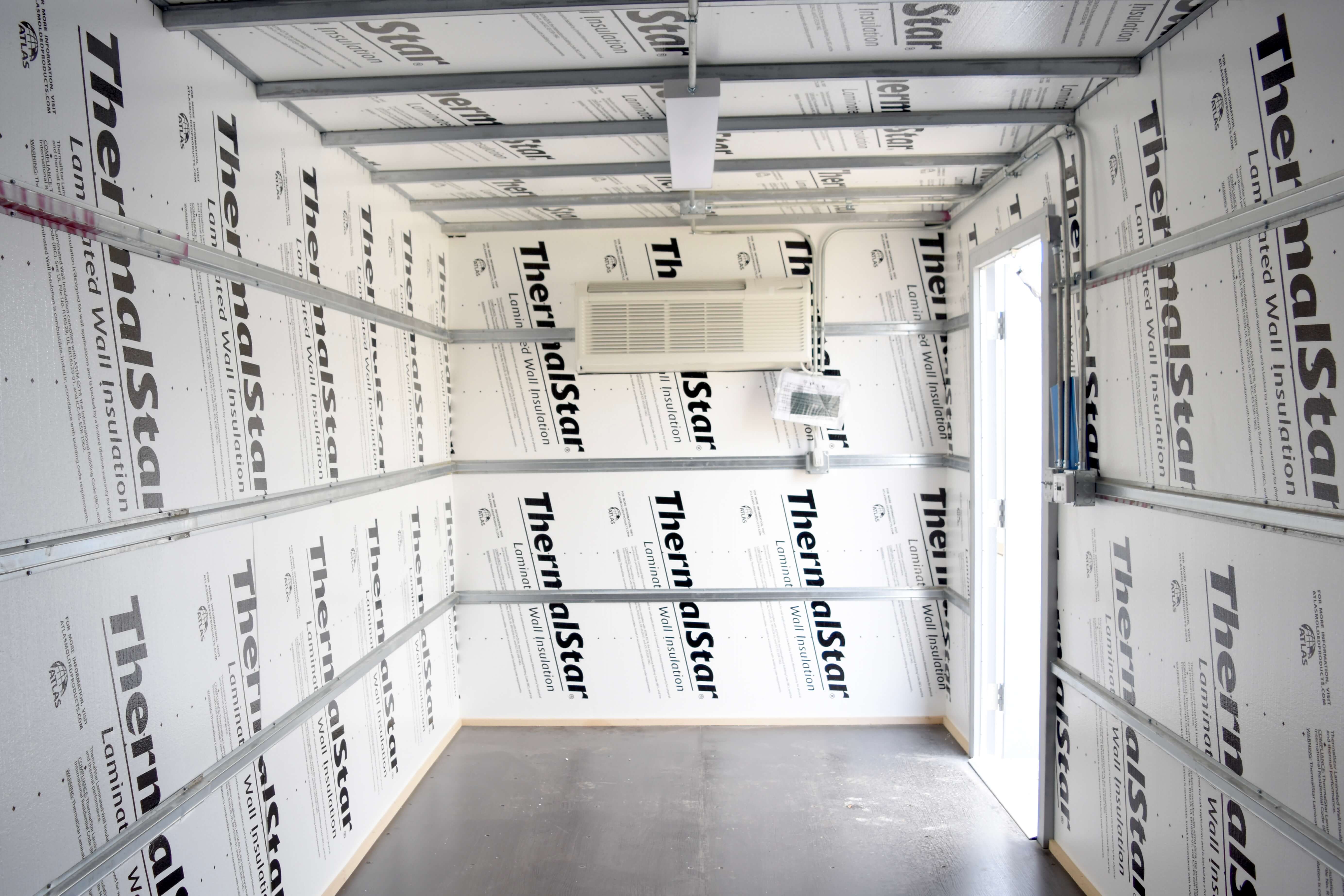 storage interior with styrofoam, ptac unit, and personnel door