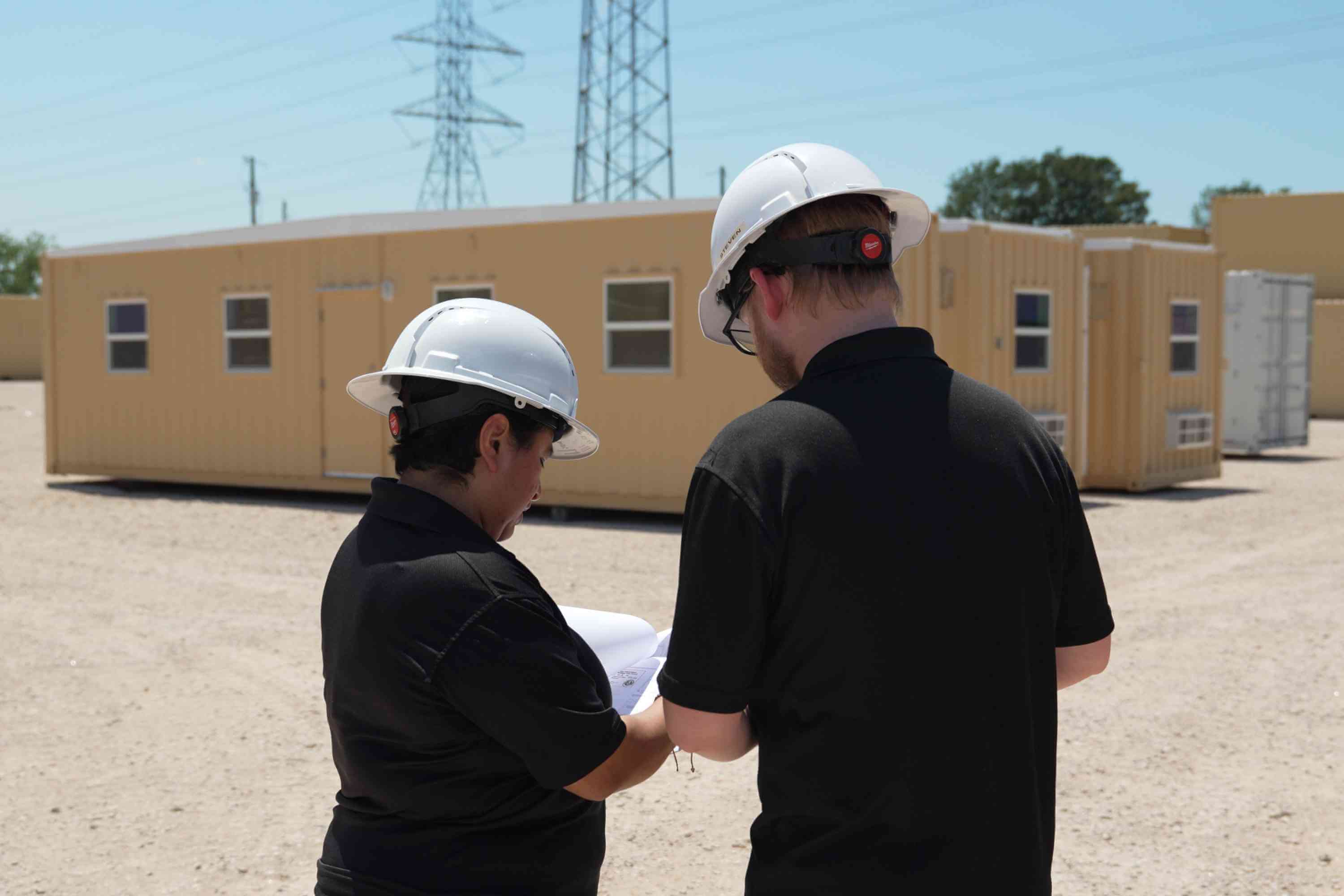 Drafters reviewing plans and completed triple wide shipping container office