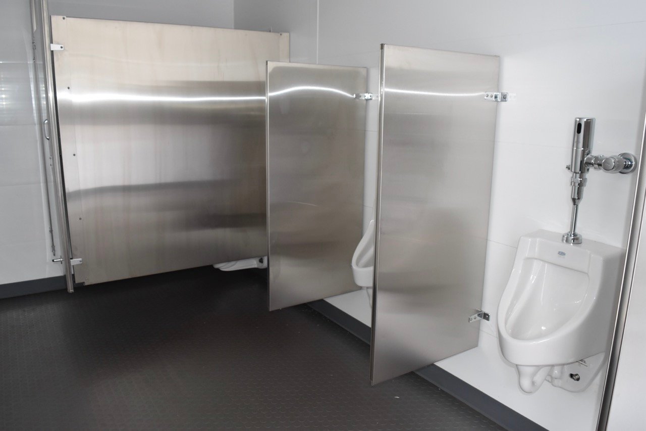 single gender bathroom with urinals and stall