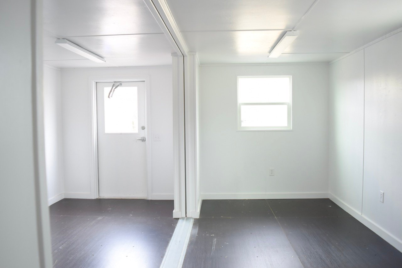 double wide structure interior with double windows and personnel door