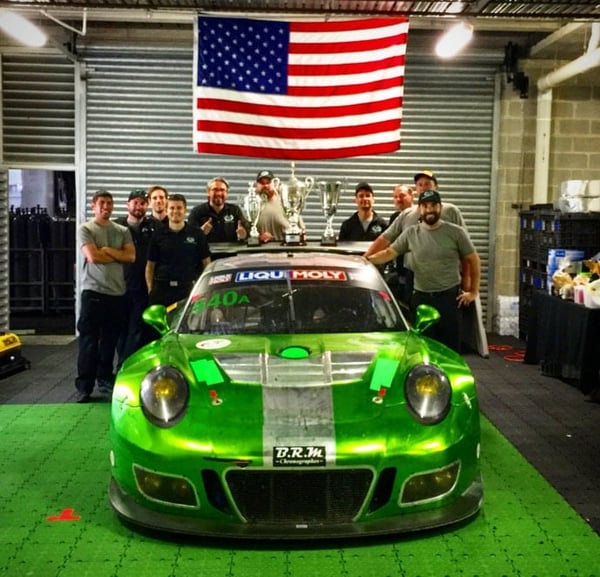 Black Swan Racing with their trophies and iconic green Porsche.