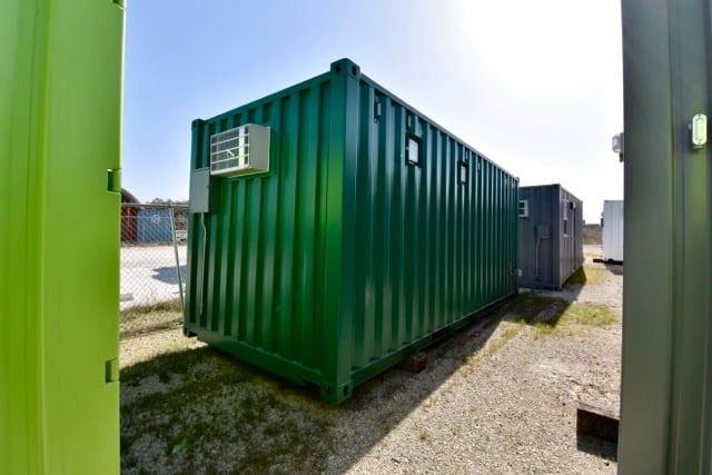 green shipping container with vents and ptac unit