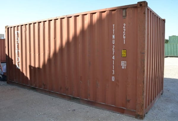 A used shipping container with a normal amount of rust.