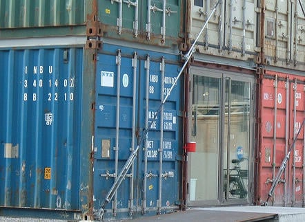 Rust on shipping containers in retail structure. Freita shop entrance, Denna Jones, 2006. CC-BY-2.0.