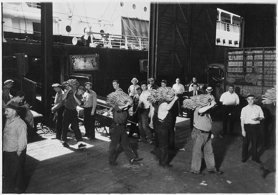 Historic image of longshoremen carrying cargo before shipping containers came into commercial use