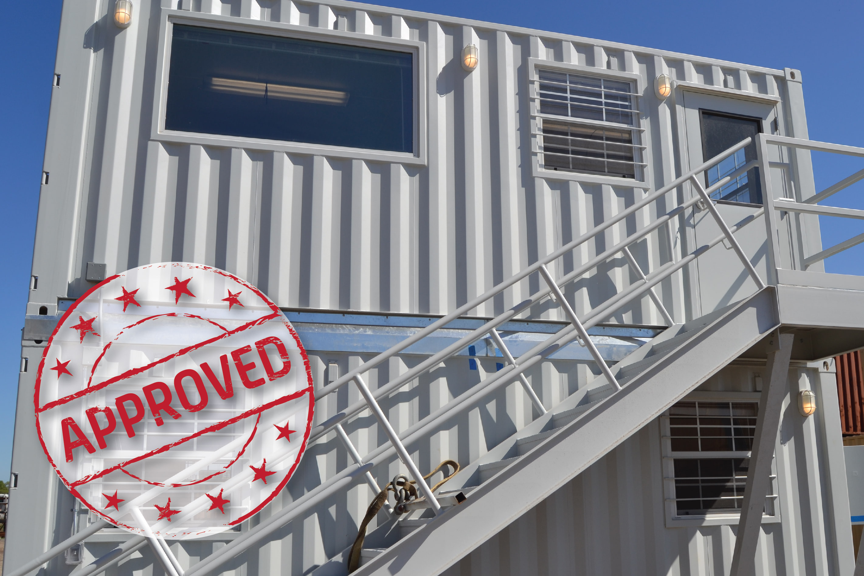 an architect and engineer walk between shipping container structures