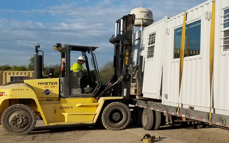 forklift removing container from flatbed