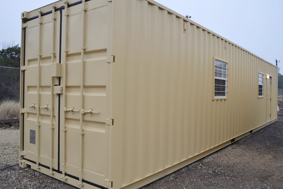 two men looking at a modified shipping container in production