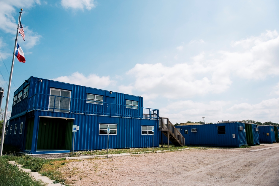 shipping containers being modified into shops in a larger structure